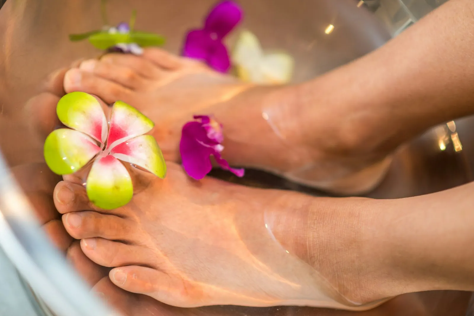 Spa pedicure foot bath with pink orchids