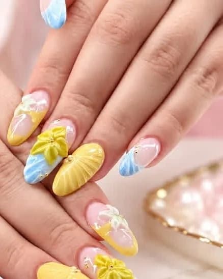 Builder gel and hard gel almond nails with yellow and blue 3D sculpted flowers by Jasmine Nails & Spa, Port Washington
