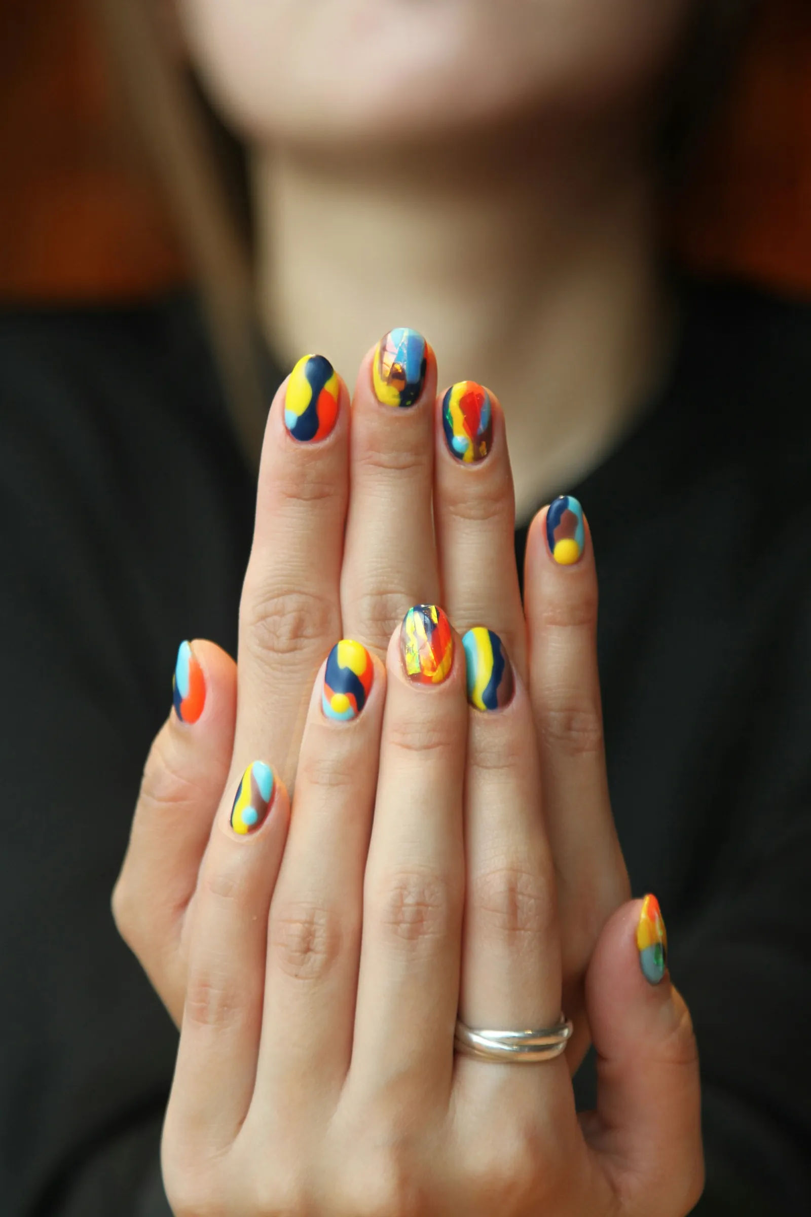 Colorful rainbow nail art on both hands
